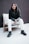 woman in black leather jacket sitting on brown wooden armchair