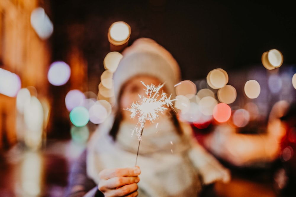 person holding white dandelion flower