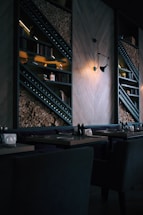 Warm rustic restaurant interior with glowing embers and wooden tables