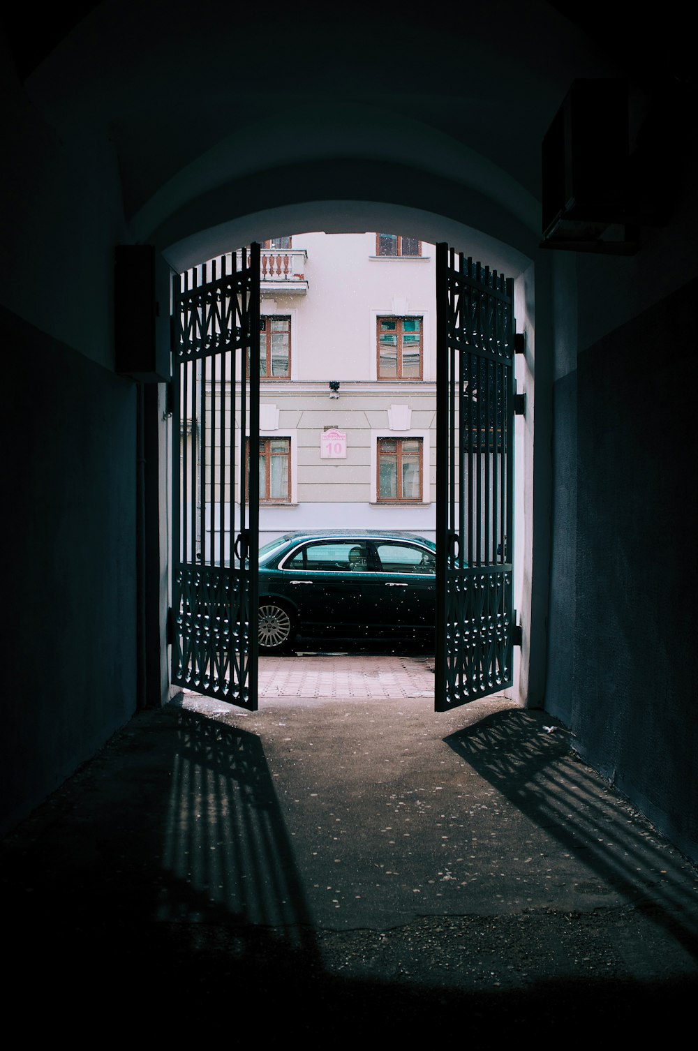 black car parked in front of white building