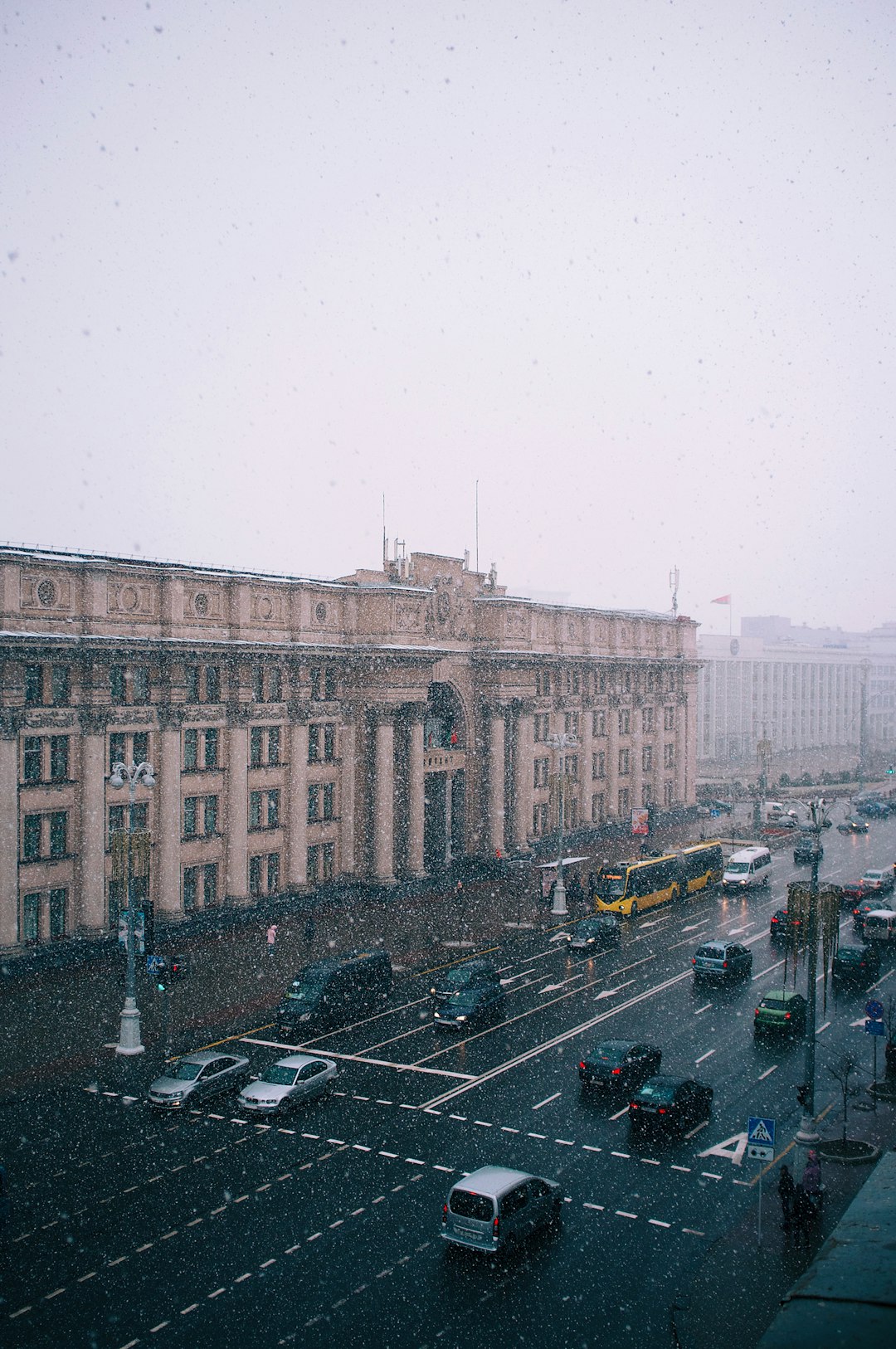 cars parked in front of brown concrete building during daytime