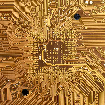 Close-up of a multilayer PCB with intricate high-speed signal traces and thermal vias under soft lighting.