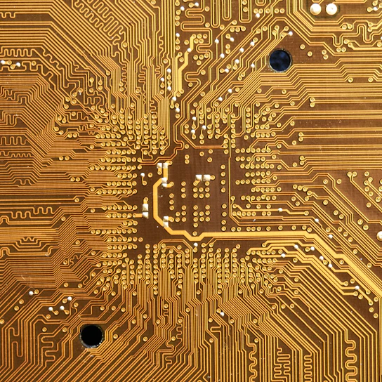 Close-up of a multi-layer PCB with intricate circuit traces and components under soft lighting.