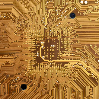 Close-up of a multi-layer PCB with intricate circuit traces glowing under soft light.