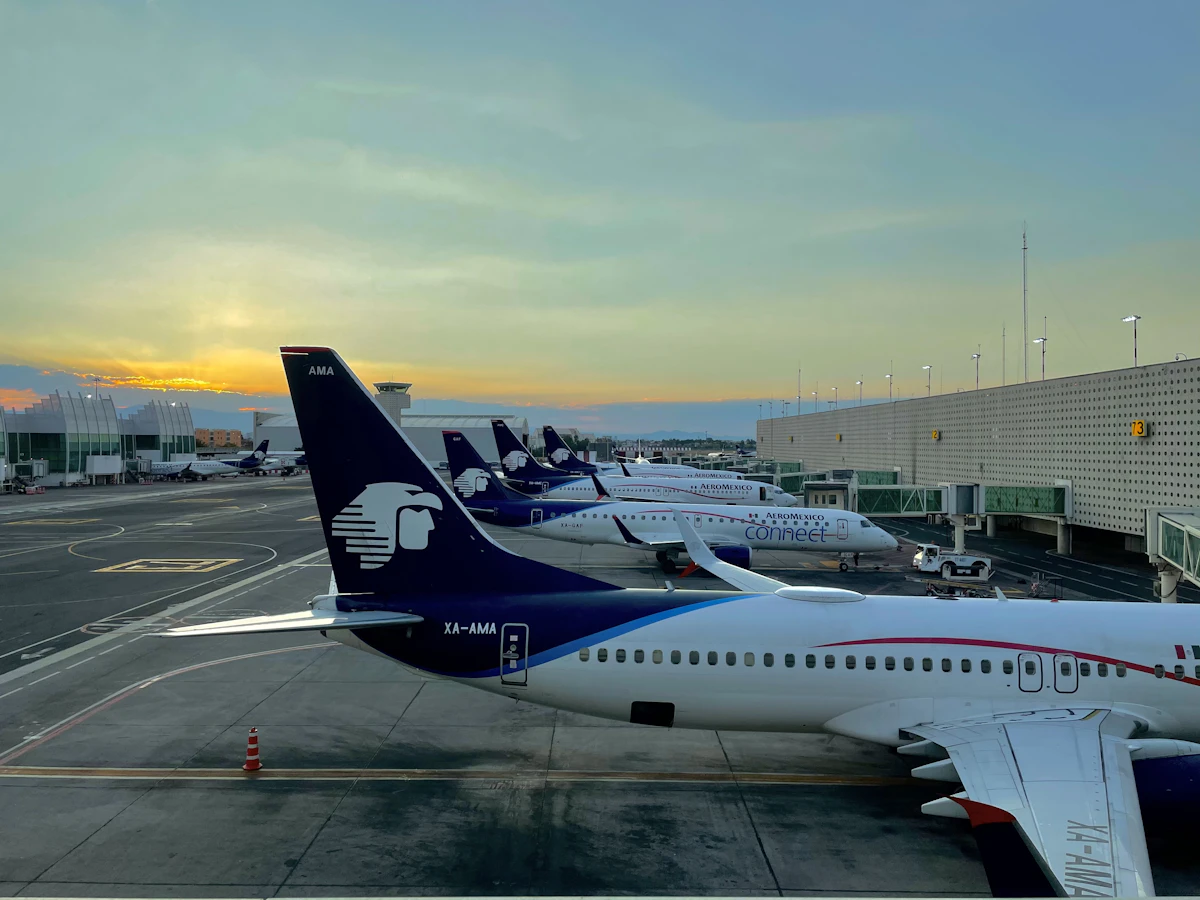 A white and blue passenger jet parked at an airport