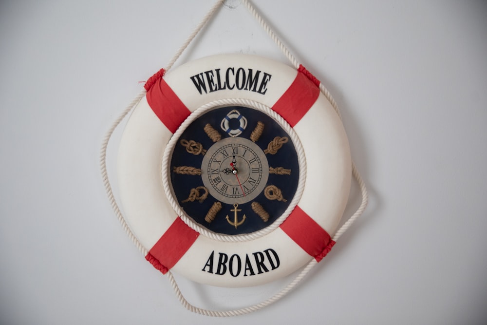 a life preserver hanging on a wall with a welcome aboard sign