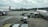 Airplanes are parked on an airport tarmac with airport ground handling vehicles and personnel around them. One plane has a colorful livery promoting 'Sustainable ASEAN Tourism', while another displays airline branding. The scene includes overcast skies and distant background buildings.