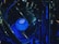 A close-up view of a computer's internal hardware components, including a central processing unit (CPU) cooler with a prominently displayed Intel logo. The lighting has a blue tone, highlighting the intricacy of the various cables, circuit boards, and heat sinks in the assembly.