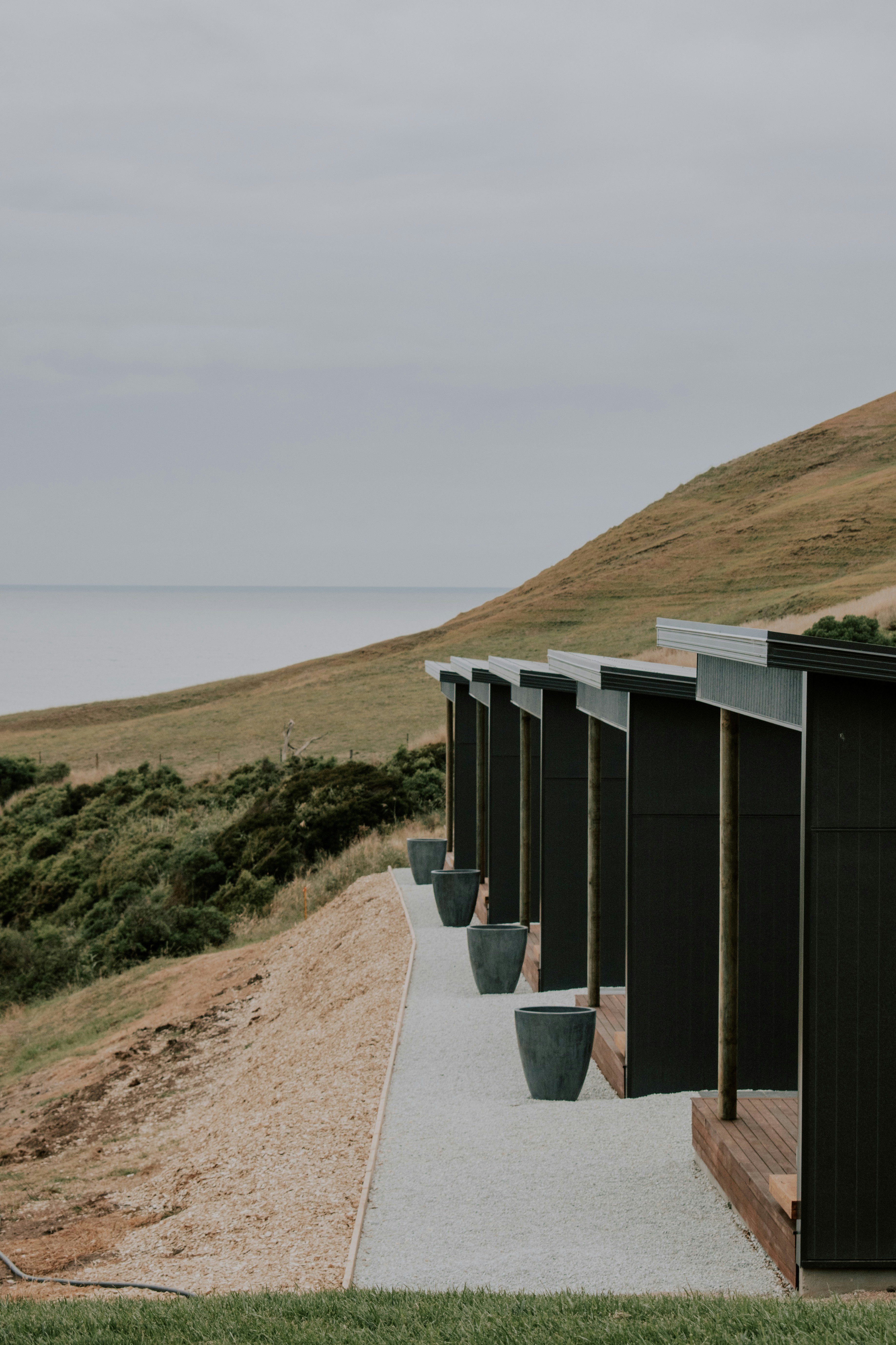 brown wooden shed on brown hill during daytime