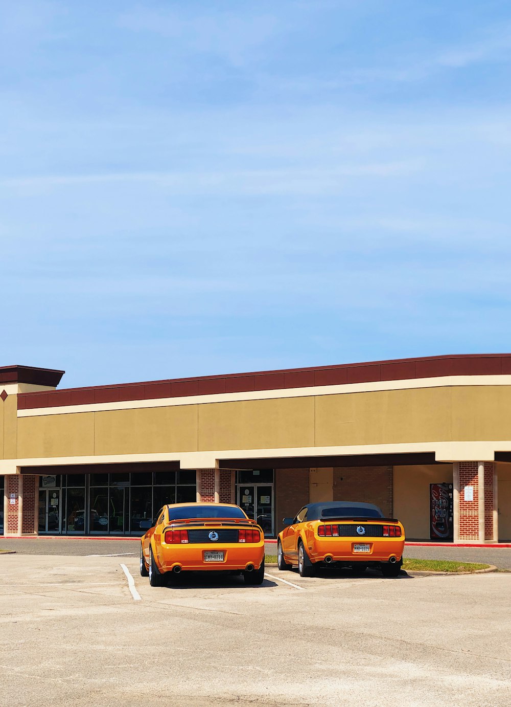 yellow sedan parked near brown concrete building during daytime