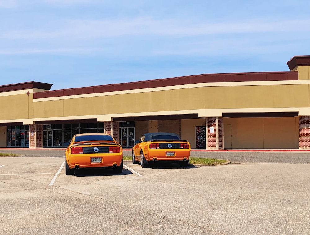 yellow car parked in front of brown building