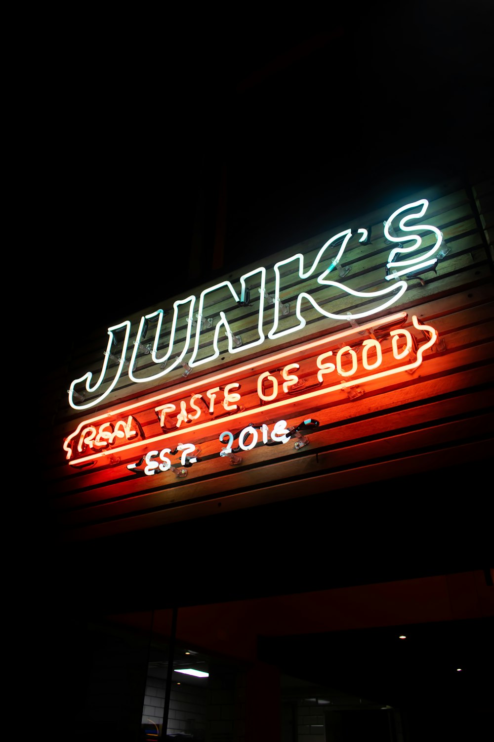 red and white UNKs coffee neon signage