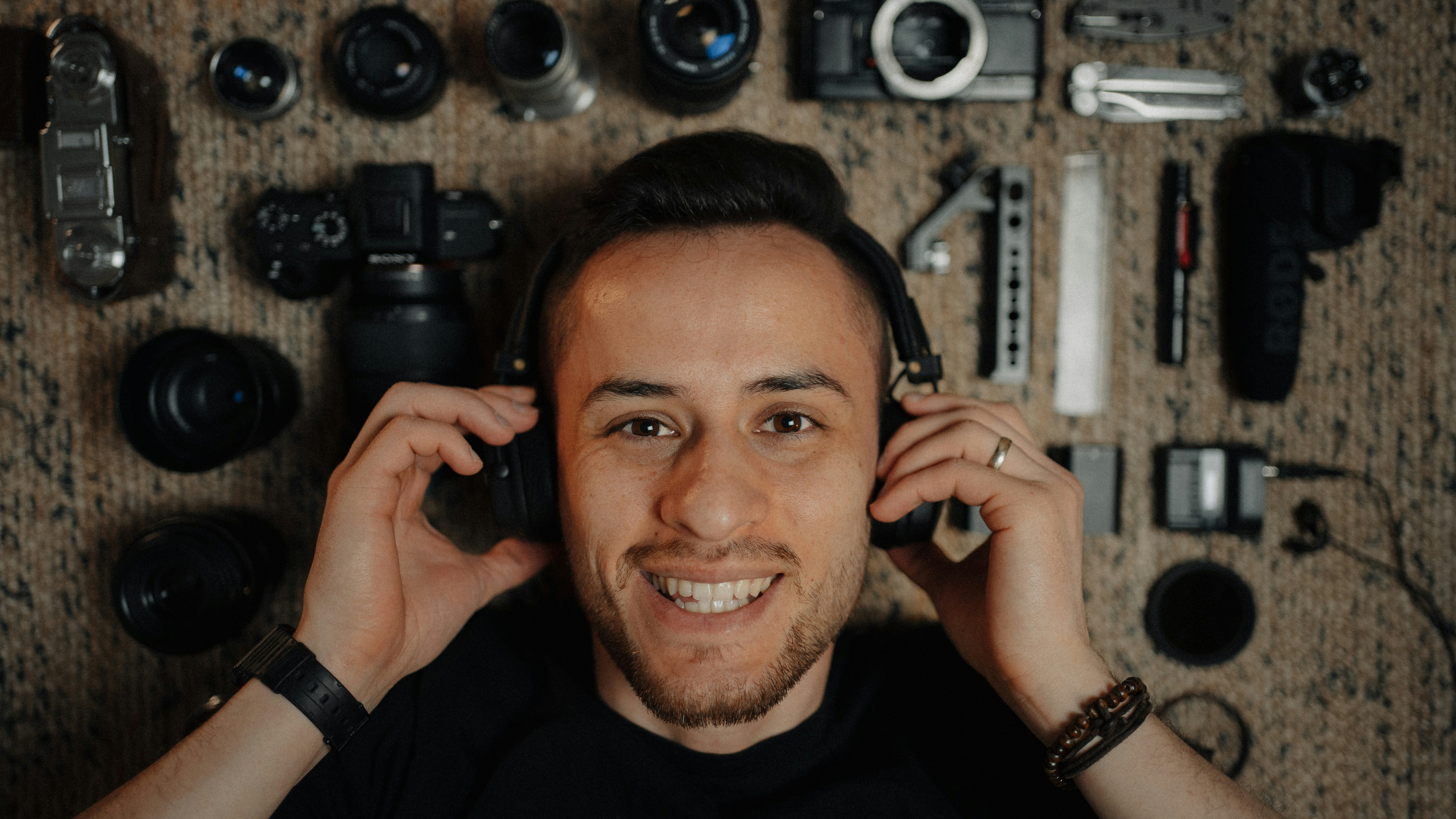 man in black crew neck shirt holding black camera
