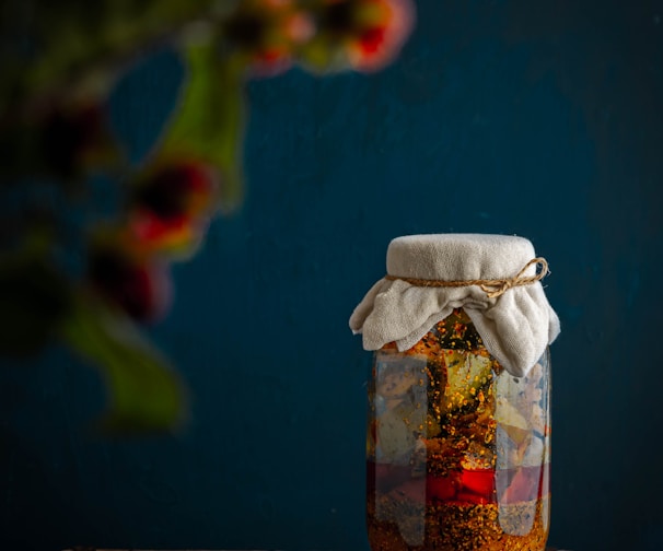 clear glass jar with white textile on brown wooden table