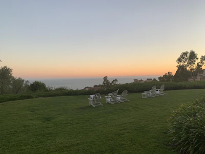 A calming lounge area overlooking the ocean at sunset.