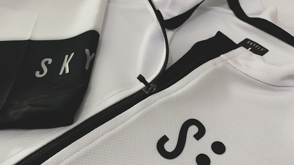 Close-up of a premium sport jacket featuring detailed embroidered angel wings on the shoulder.