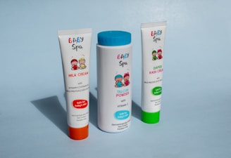 white and green tube bottle