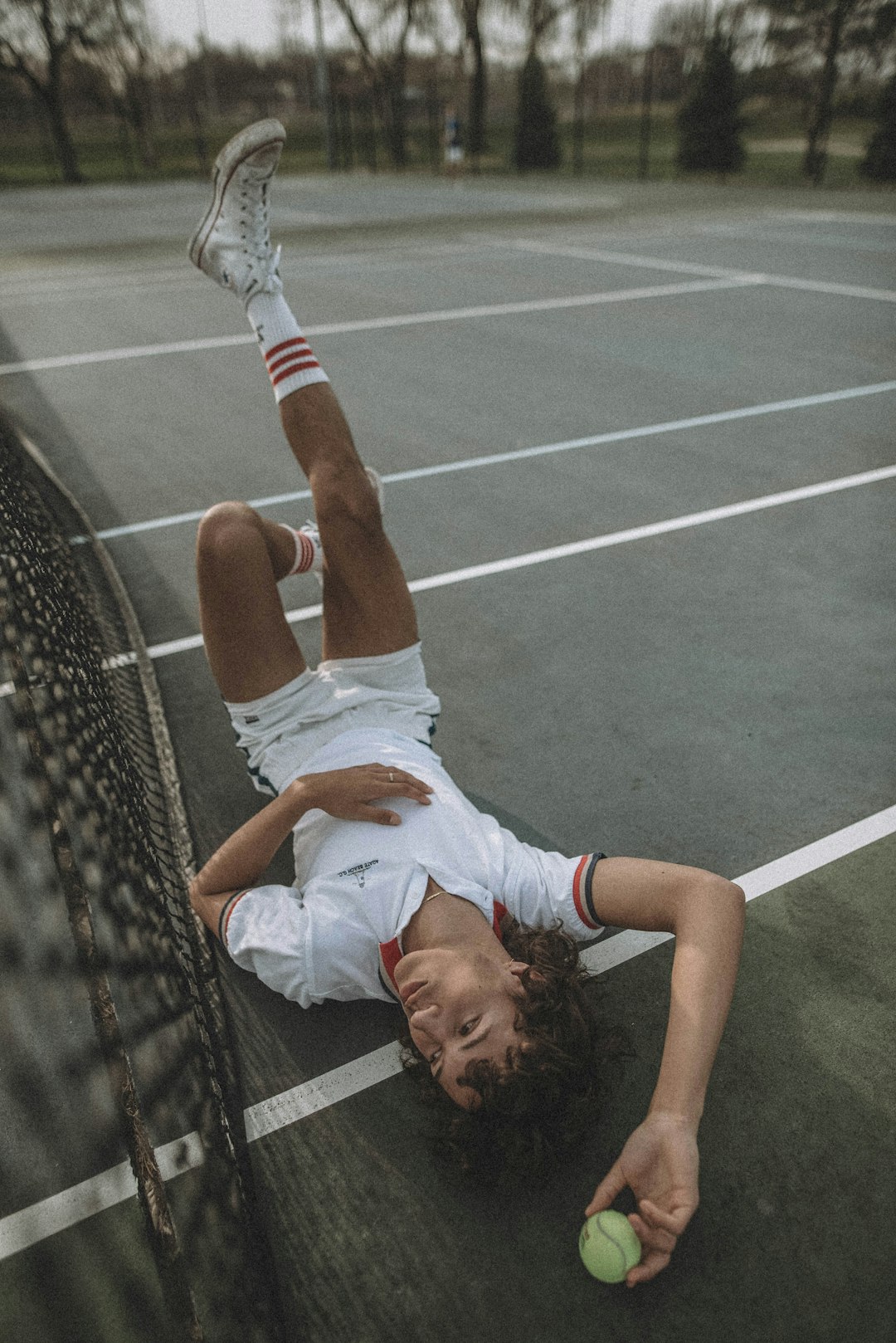 woman in white t-shirt lying on brown and black net