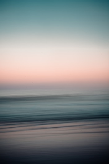 body of water under cloudy sky during daytime