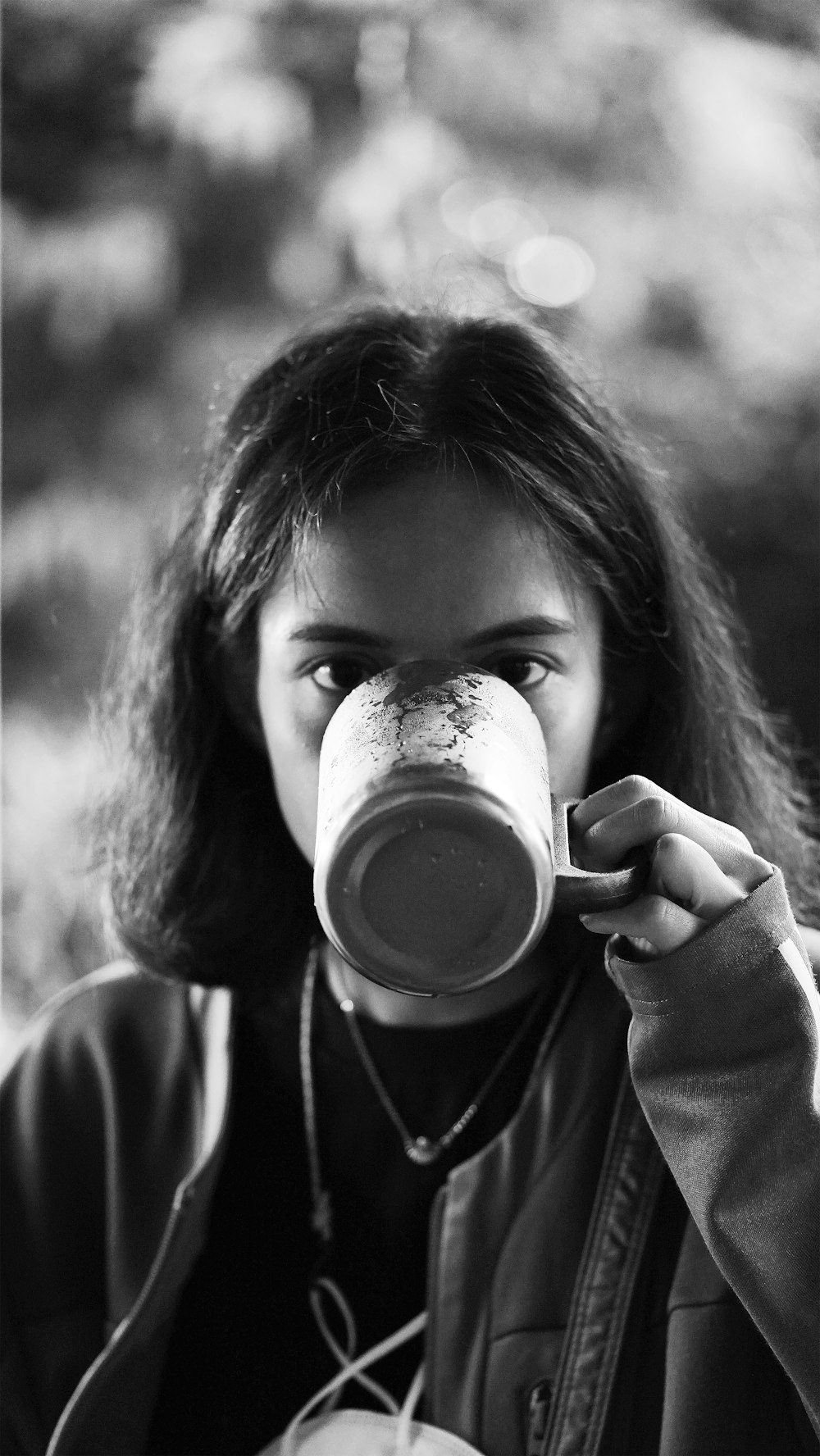 grayscale photo of woman drinking from cup
