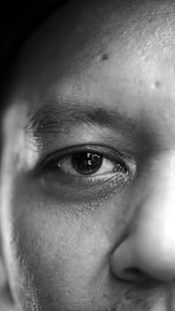 grayscale photo of persons eye
