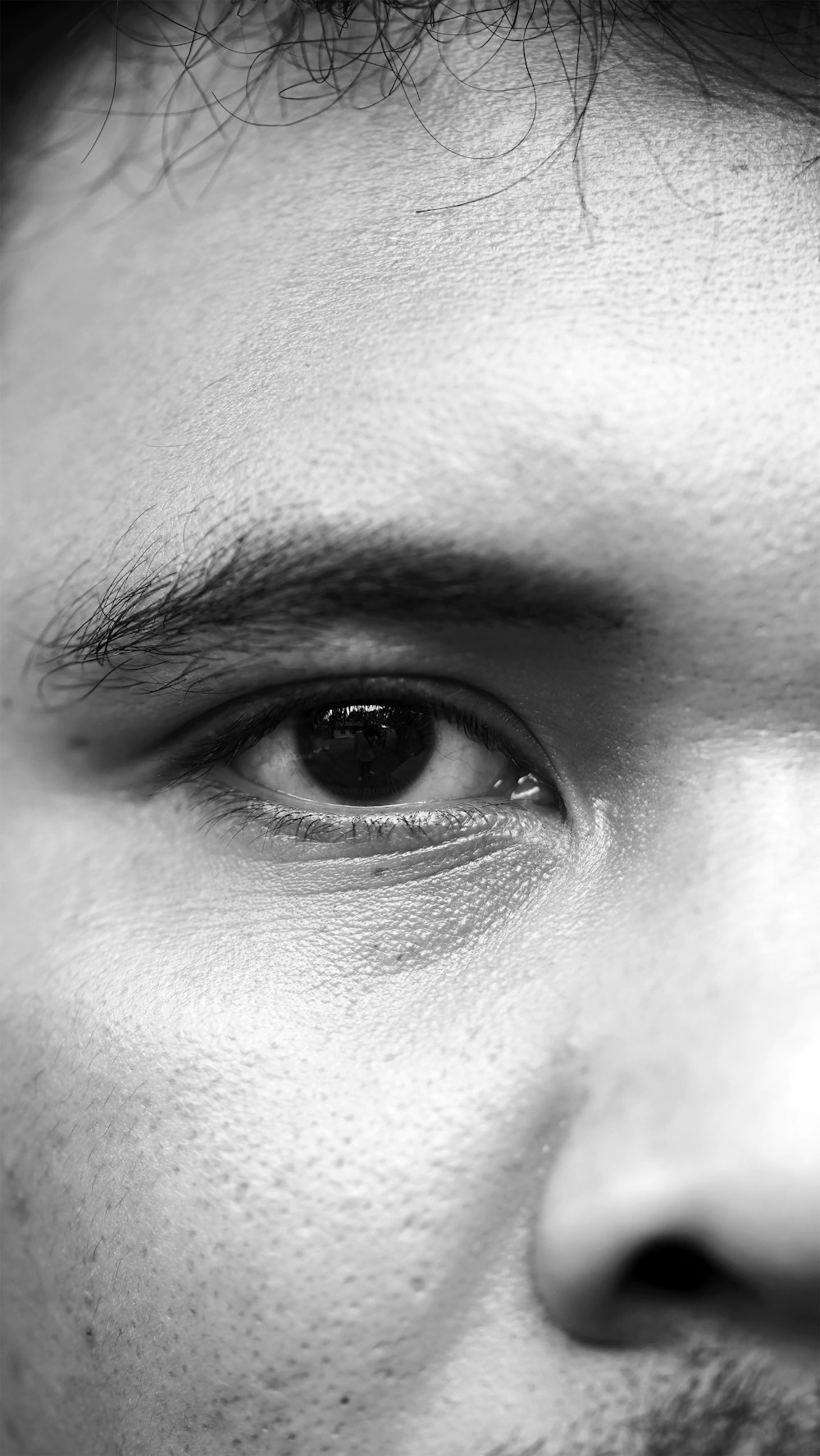 grayscale photo of human eye