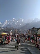 people walking on street near mountain range during daytime