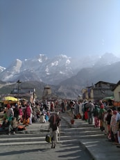 people walking on street near mountain range during daytime