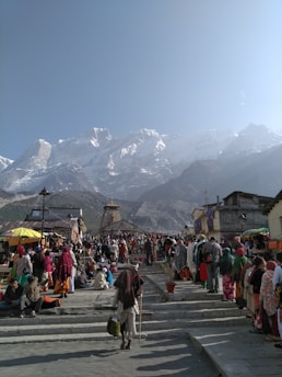 people walking on street near mountain range during daytime