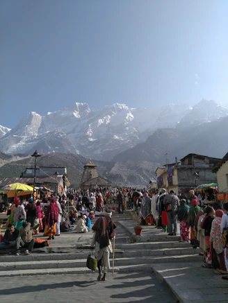 people walking on street near mountain range during daytime
