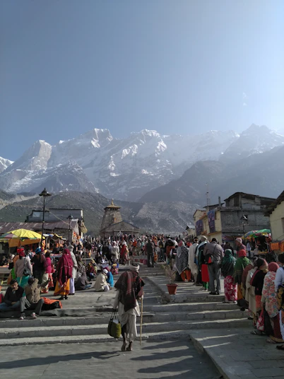 people walking on street near mountain range during daytime