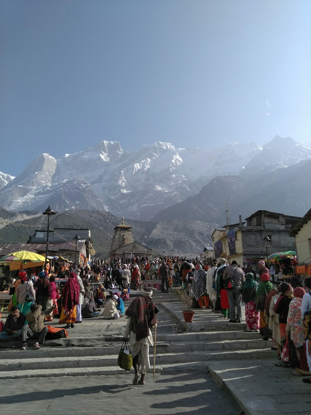 people walking on street near mountain range during daytime