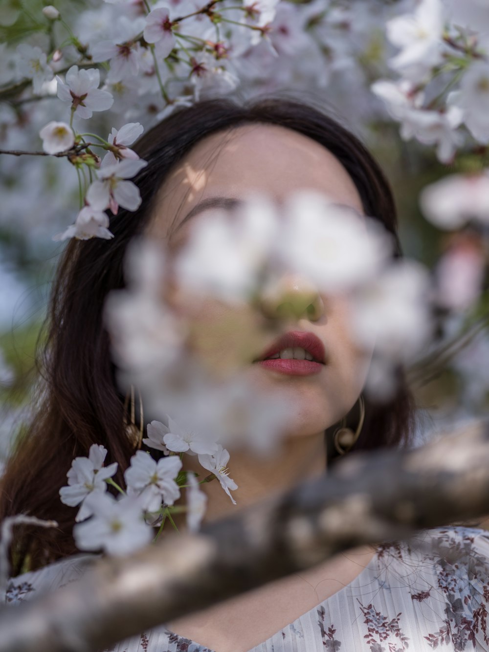 woman with white flower on her face