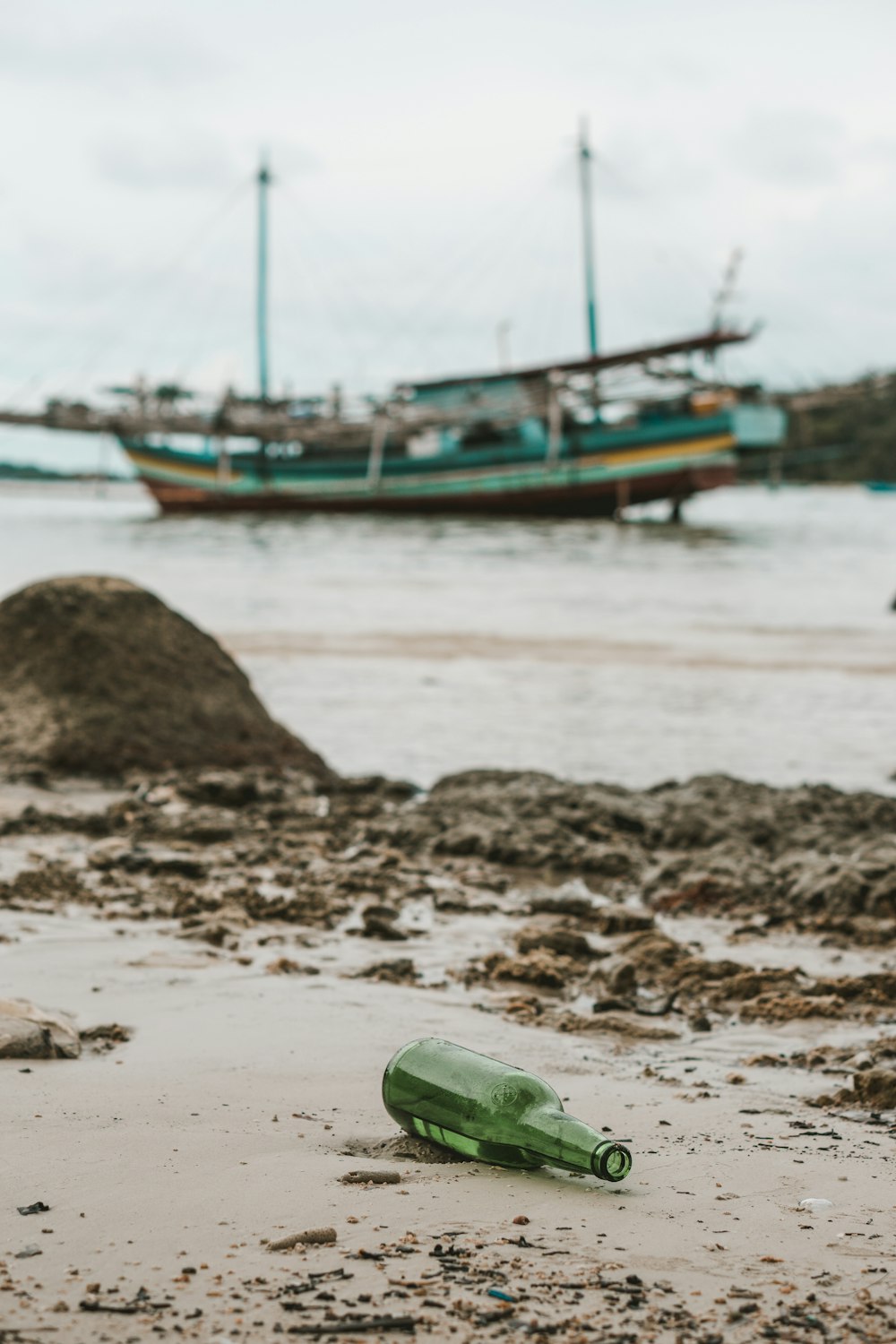 green and white boat on beach during daytime