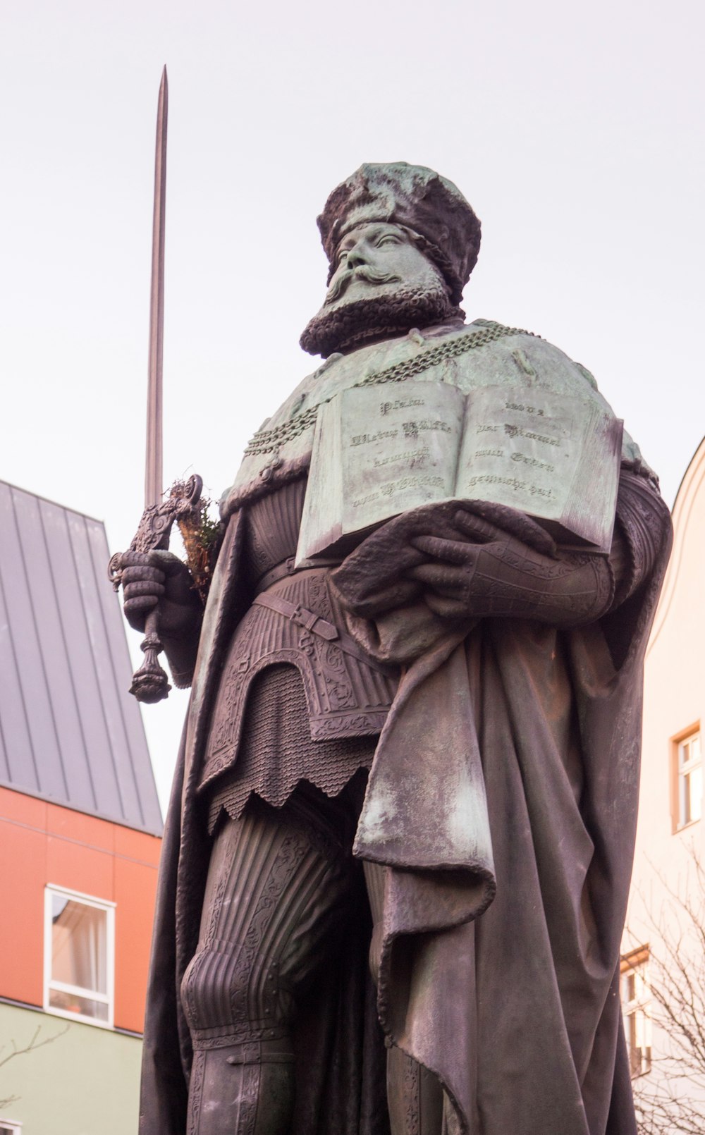 man holding a sword statue