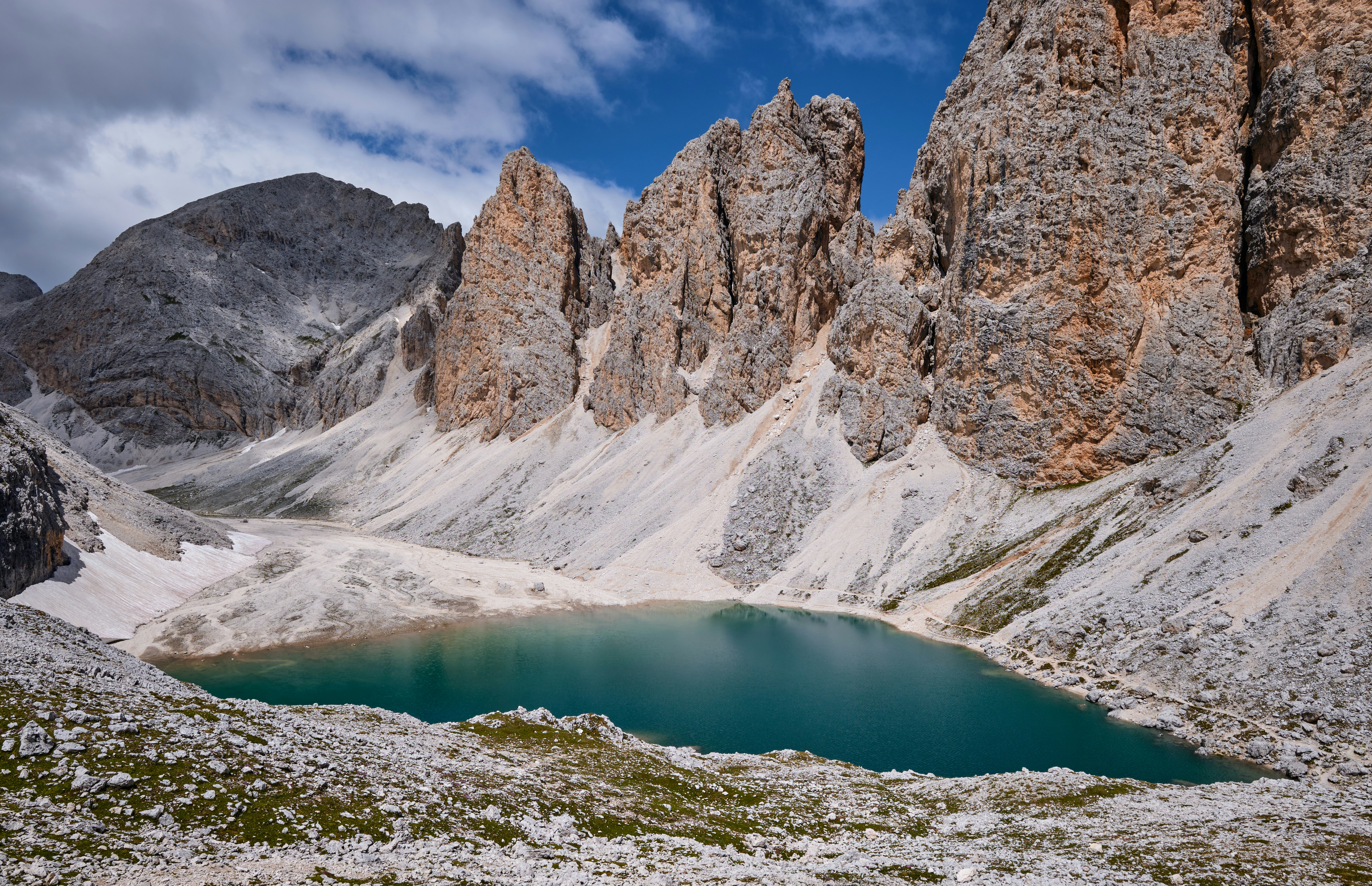 Montagna rocciosa marrone vicino al lago durante il giorno
