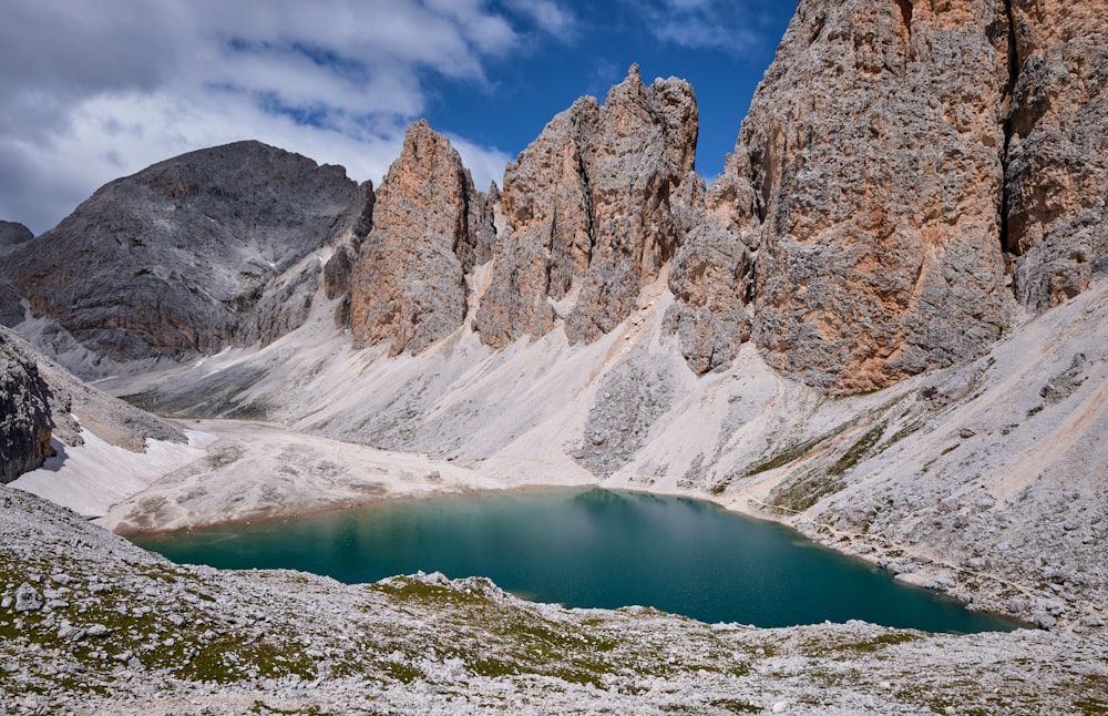 brown rocky mountain near lake during daytime