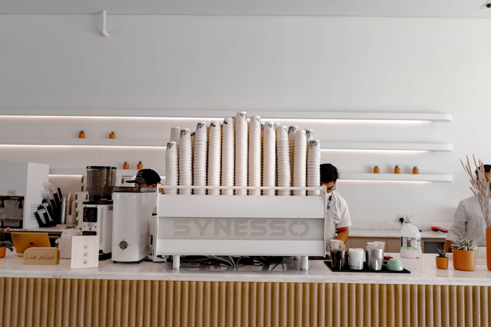 man in white dress shirt standing in front of white kitchen counter