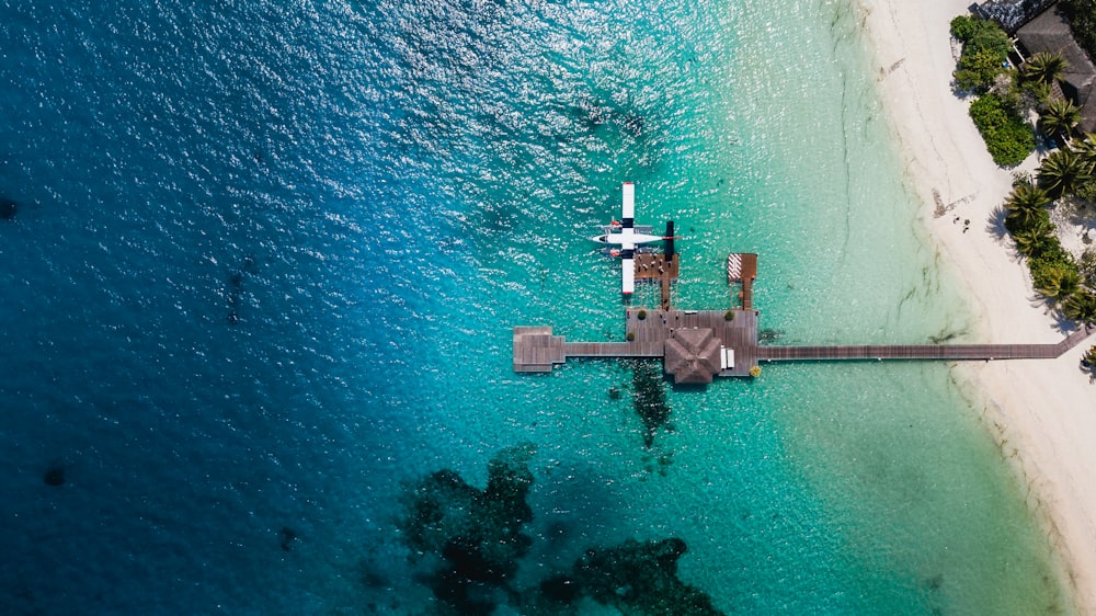 aerial view of gray concrete dock on body of water during daytime