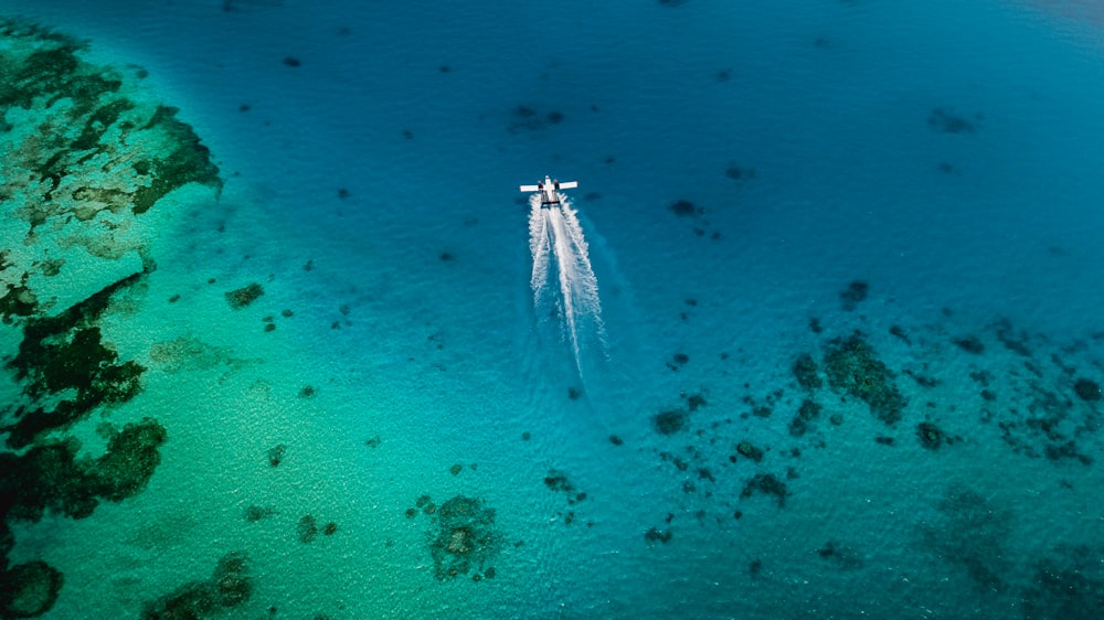 white boat on body of water during daytime