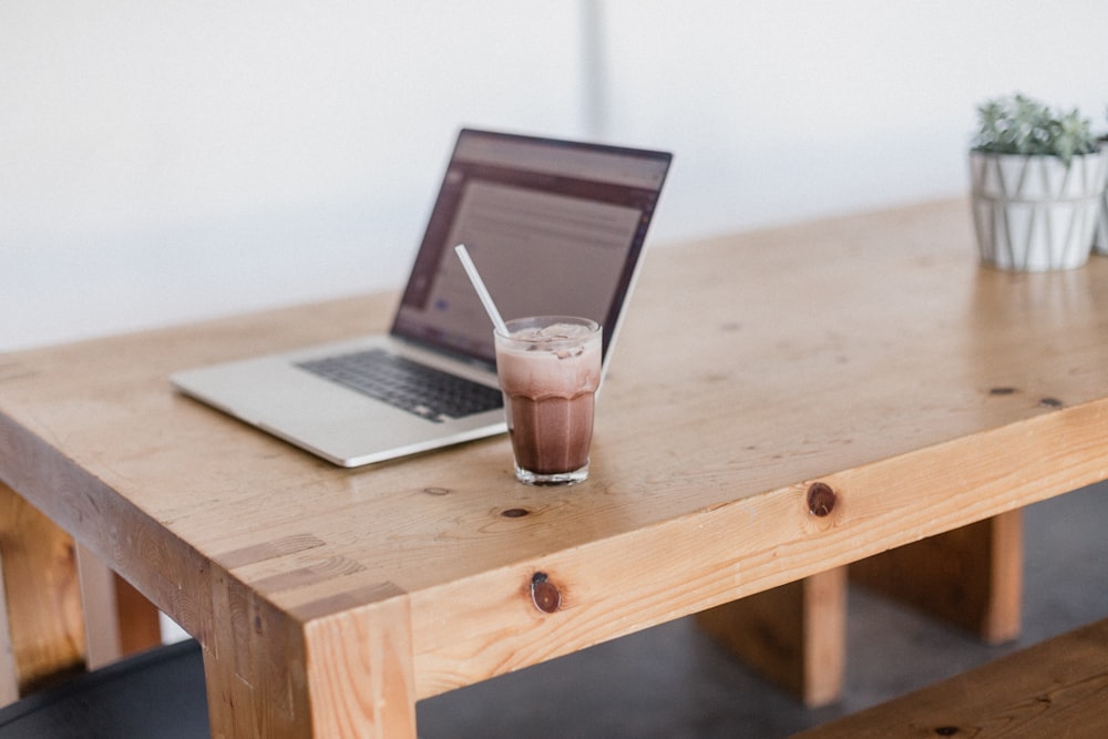 clear drinking glass on brown wooden table