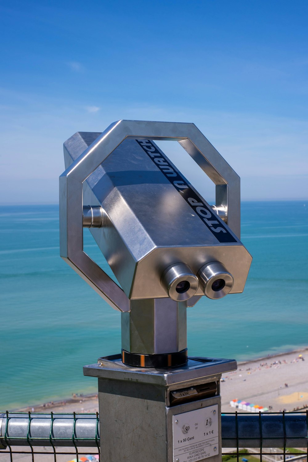 gray and black telescope on blue sea under blue sky during daytime
