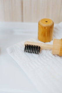 brown wooden rolling pin on white textile