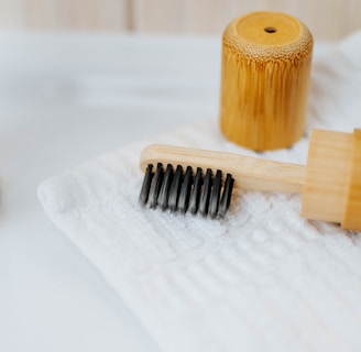 brown wooden rolling pin on white textile