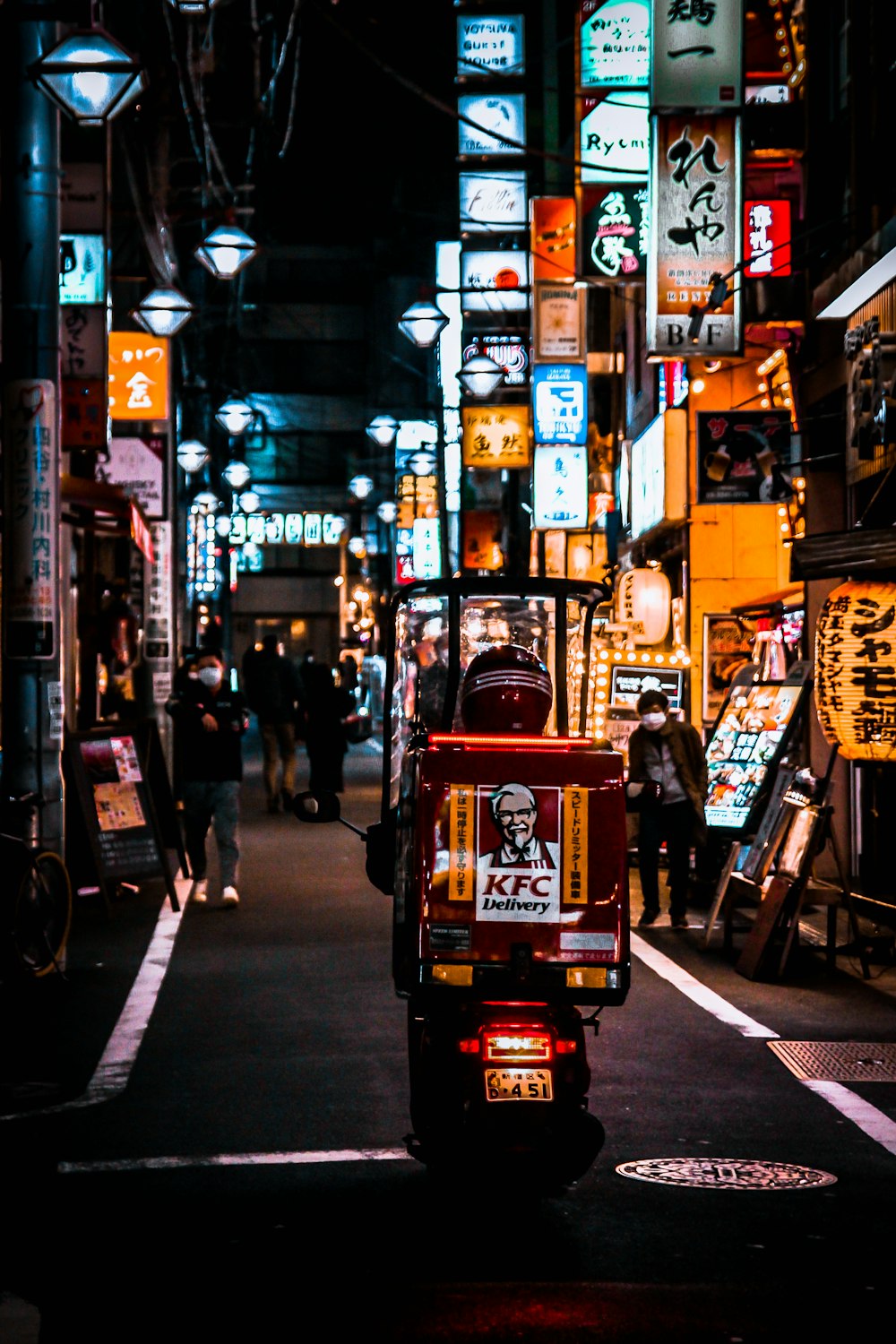 red and black auto rickshaw on road during nighttime