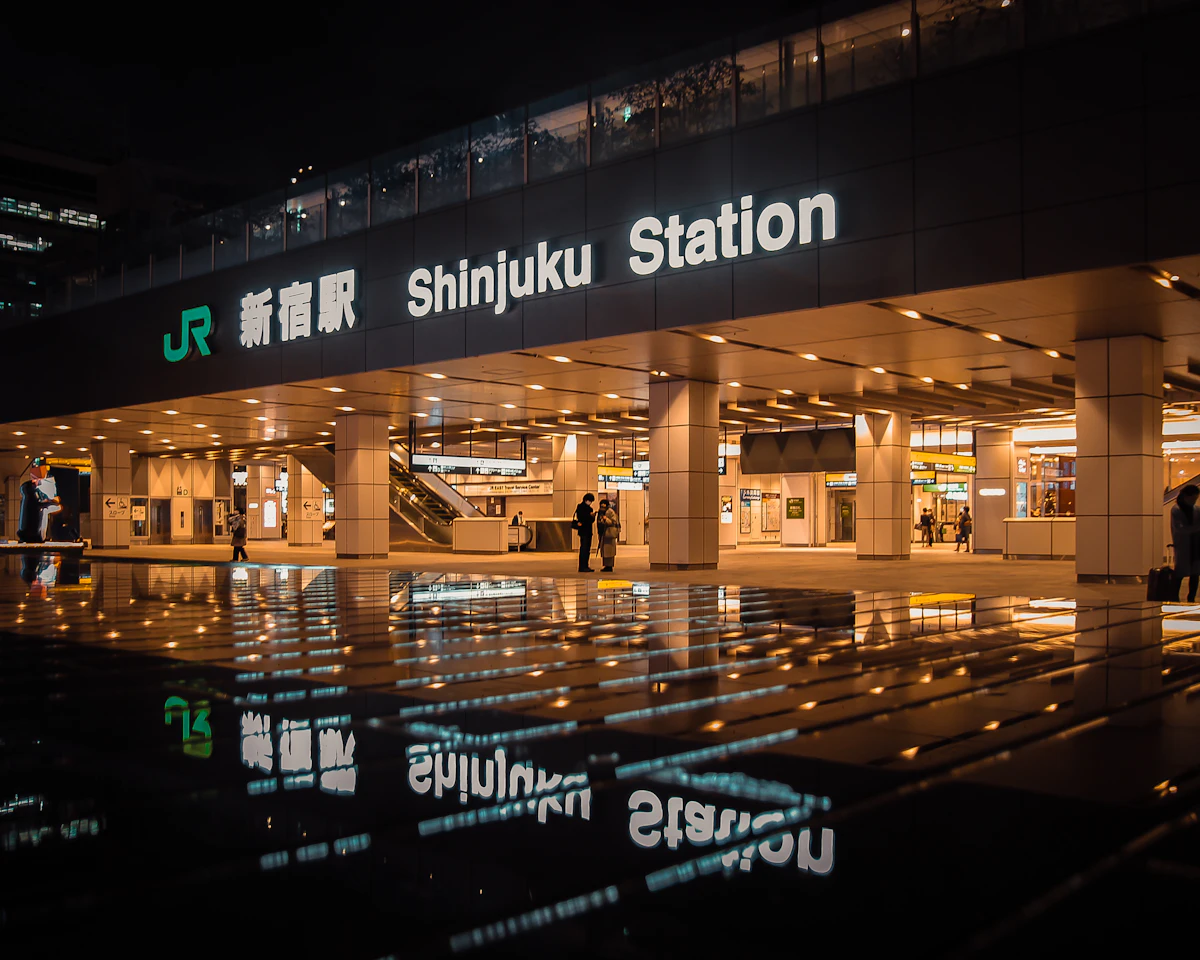 Tokyo Station Marunouchi entrance lit up at night, showing the red brick facade