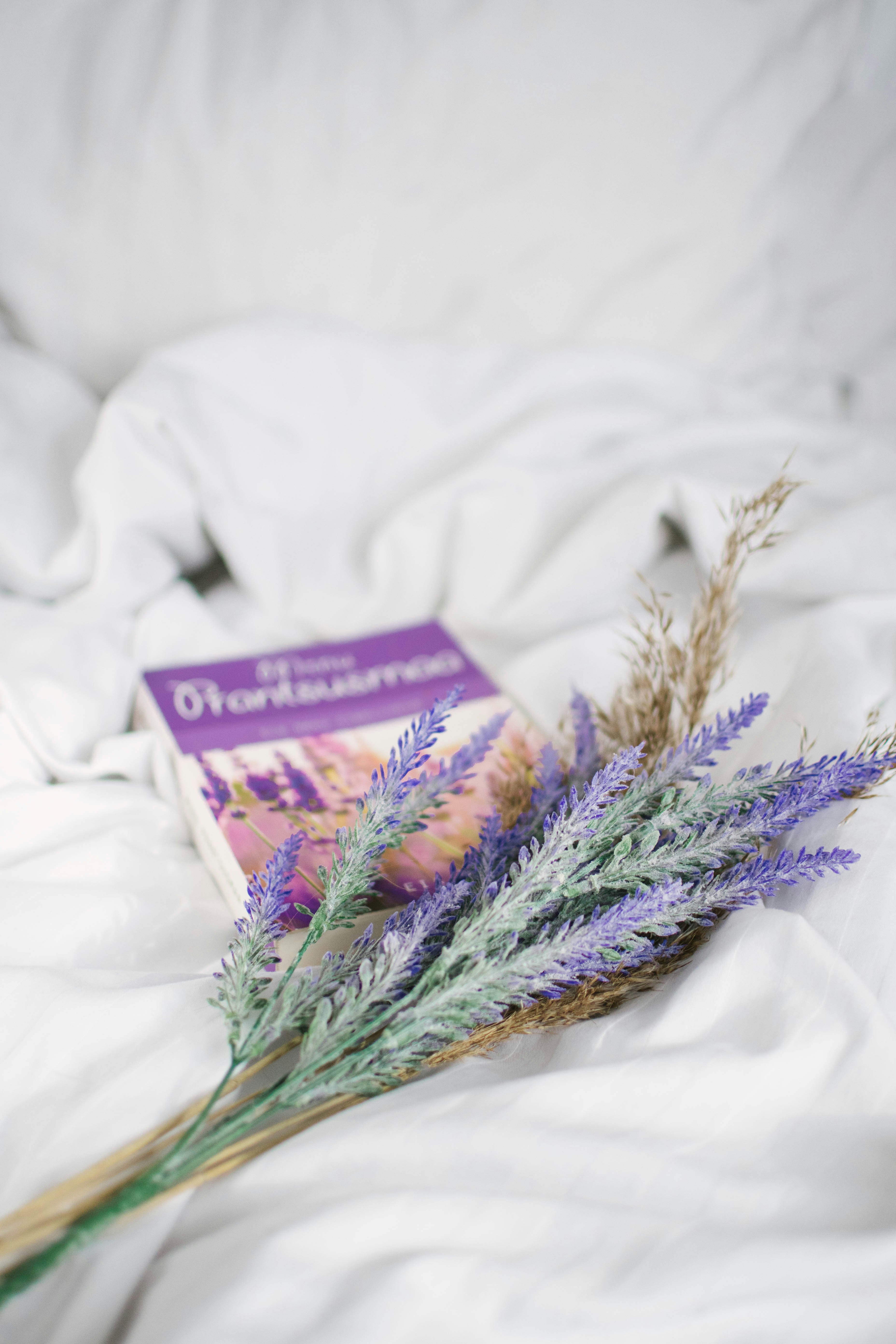 purple and white flowers on white textile