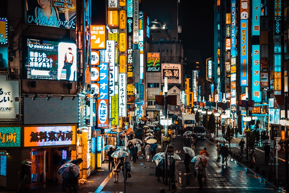 people walking on street during night time