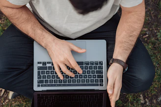A person training with a laptop outdoors, showing flexibility and freedom.