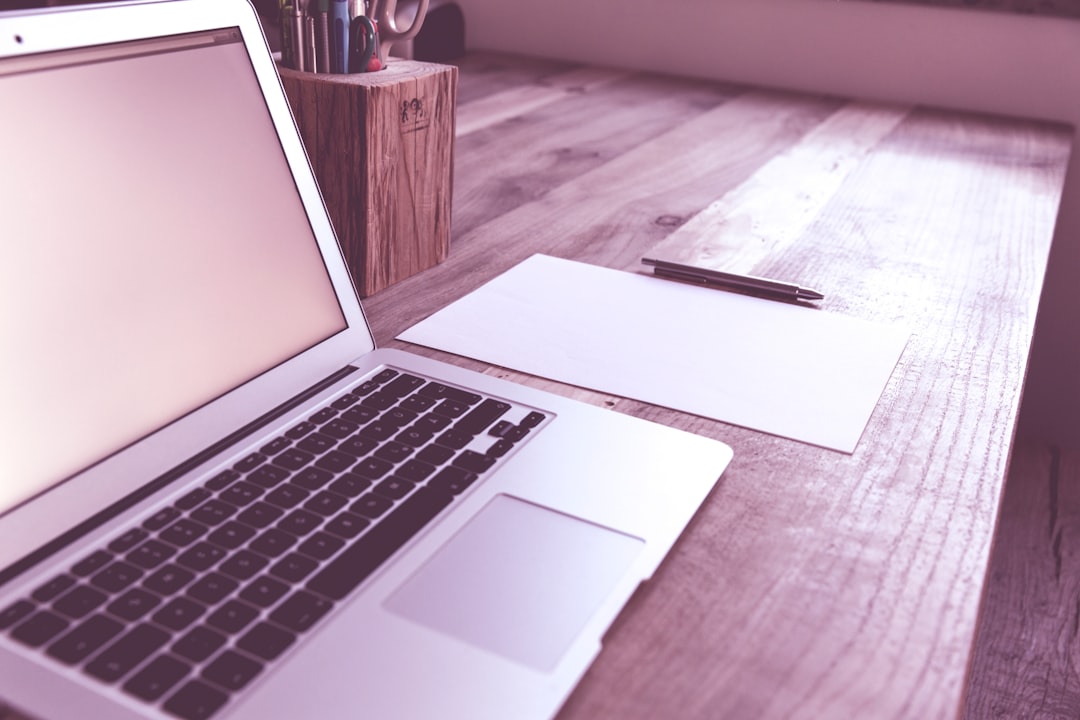 macbook air on brown wooden table